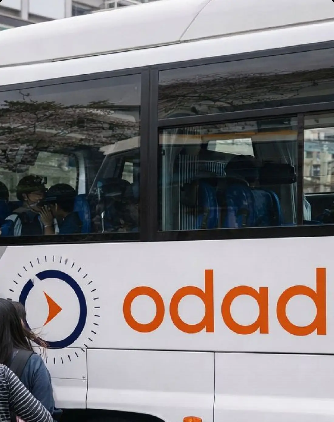 Odaduu-branded coach picking up a tour group in Japan